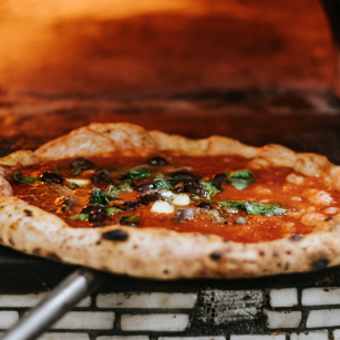 animated chef with pizza on peel between 2 pizza ovens_Door Open or Closed blog post