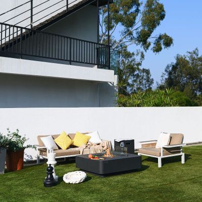 Elementi Plus Bergamo Fire table with couch in the backyard