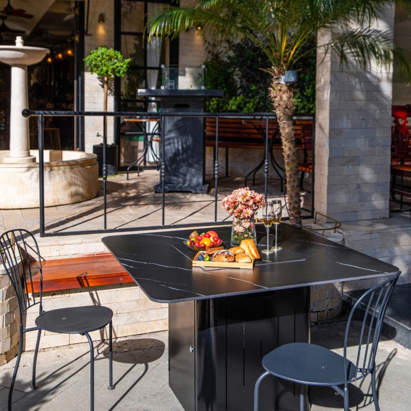 Elementi Plus Brugge Dining Fire Table with Porcelain Lid in a commercial space Outdoor