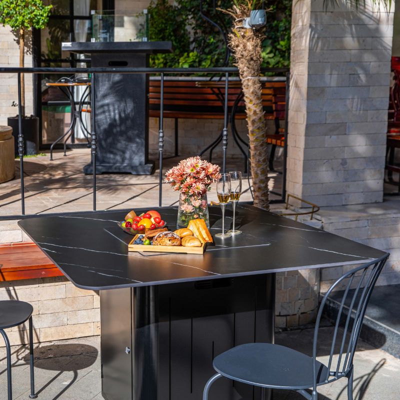 Elementi Plus Brugge Dining Fire Table with lid and snacks on top