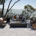 Elementi Plus Cannes Fire Table with flame and windscreen overlook yard