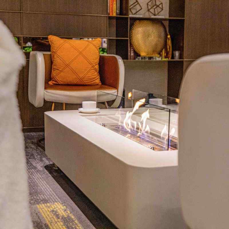 Elementi Sydney ethanol fire Pit Cream white with flame indoor set up