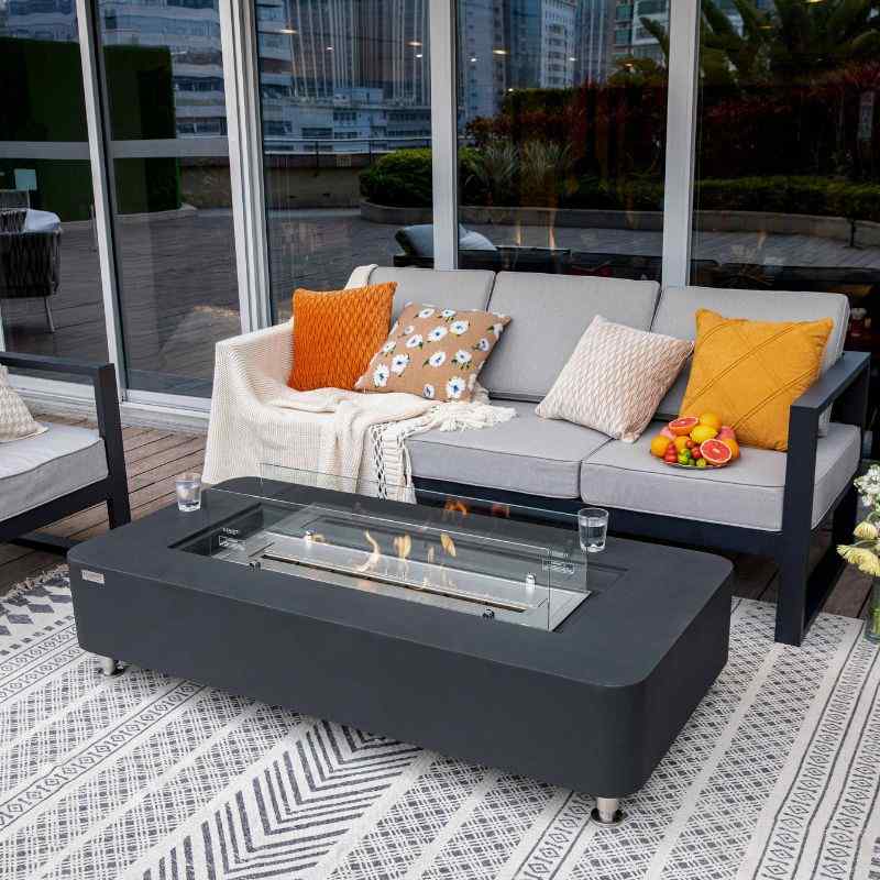 Elementi Sydney Ethanol Fire Pit Slate black with windscreen near couch