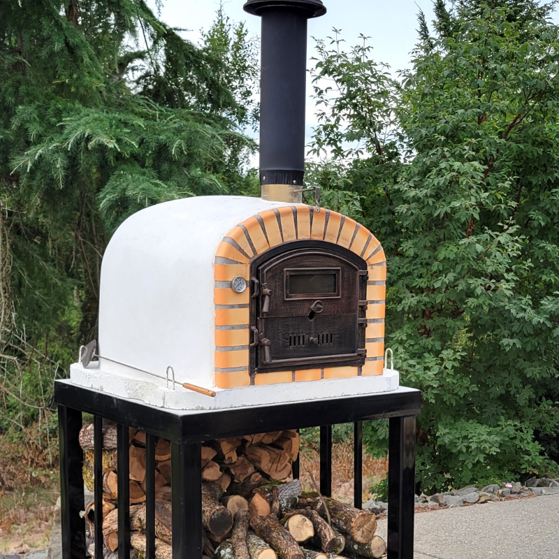 Lisbon premium pizza oven installed outdoors, featuring a modern design with a visible chimney and sturdy exterior.