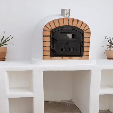 Lisboa Premium Pizza Oven resting on a sturdy shelf with door closed, showcasing its authentic rustic design
