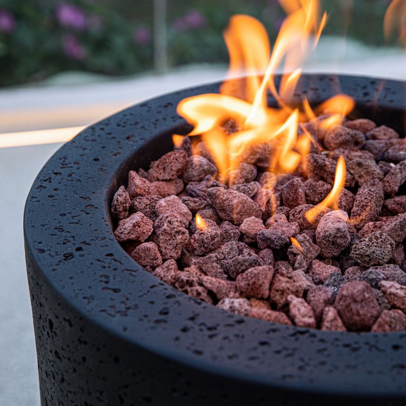 Modeno Lava Tube Fire Pit with textured material and flame close up