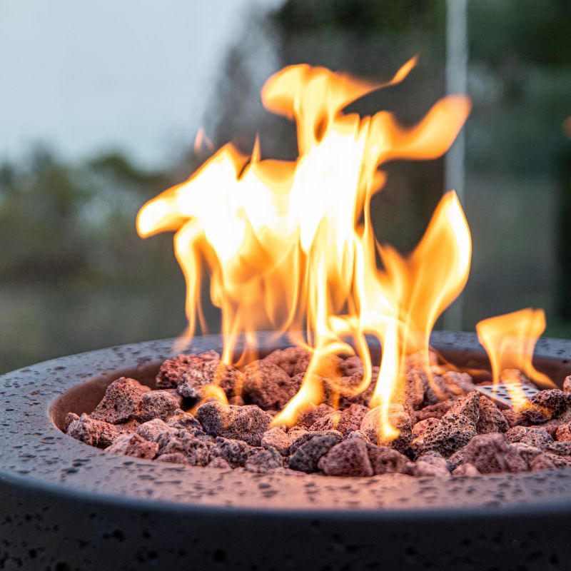 Modeno Lava Tube Fire Pit Close look of the lava rocks and flame