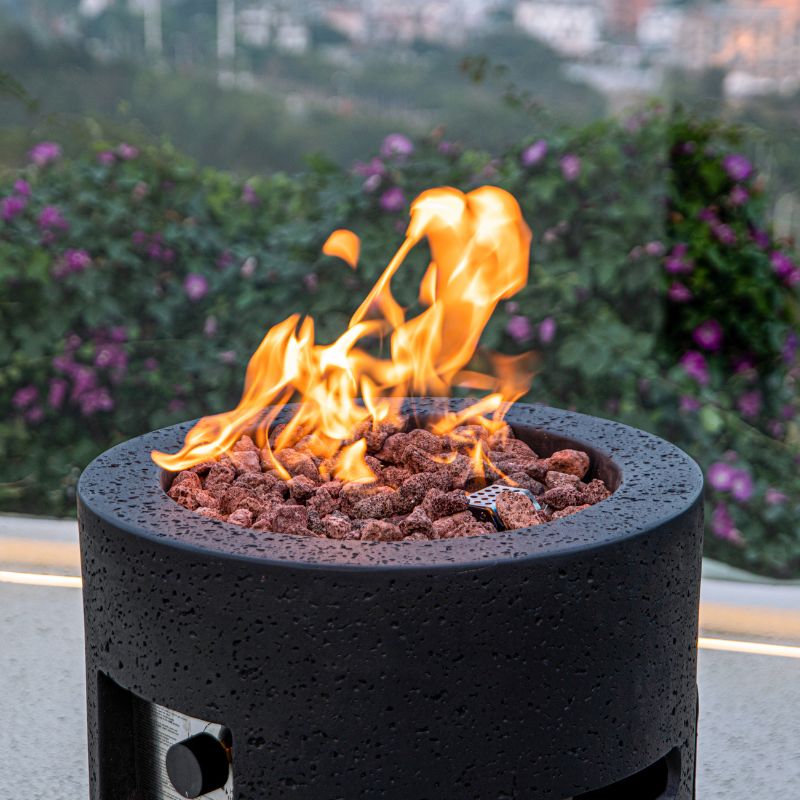 Modeno Lava Tube Fire Pit with lava rocks and flame
