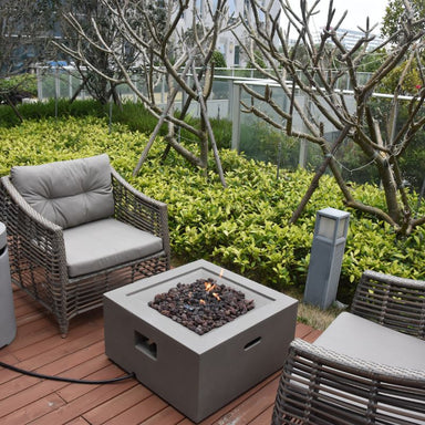 Modeno Ridgefield Fire Pit with flame near couch Backyard lifestyle