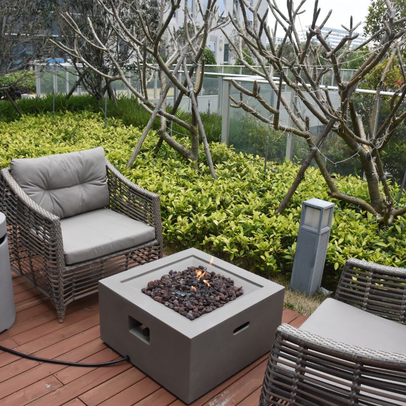 Modeno Ridgefield Fire Pit with flame near couch Backyard lifestyle