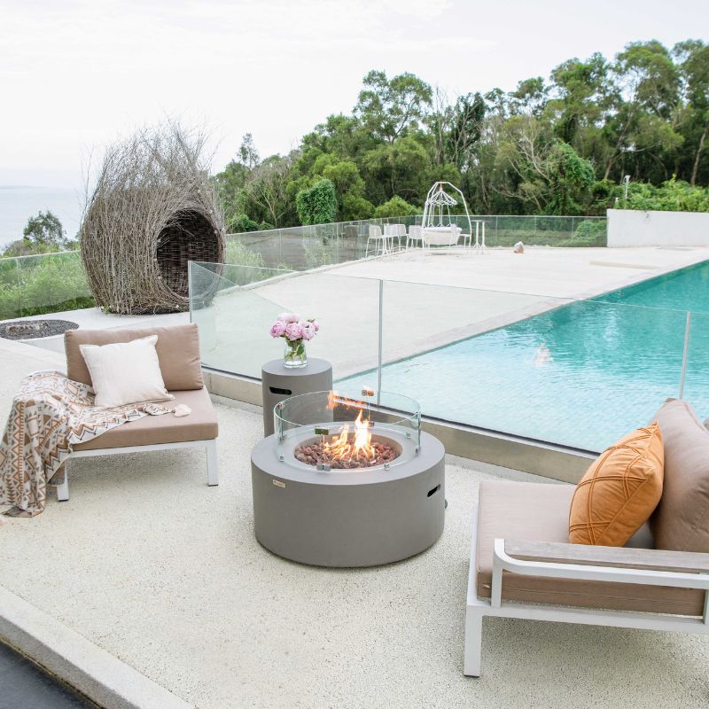 Modeno Tramore Fire Table with flame and windscreen pool side View