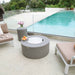 Modeno Tramore Fire Table With Lid near couch and pool