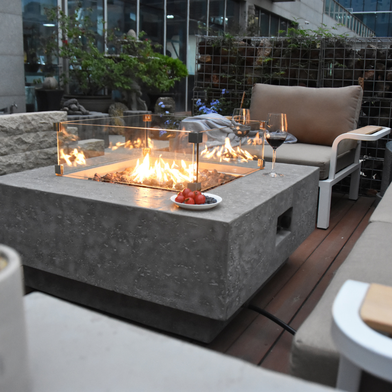 Manhattan Fire Table with Flame sofas around and wine